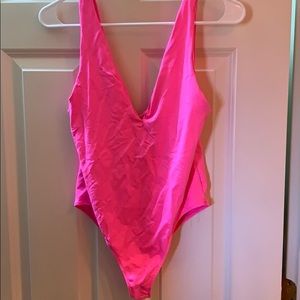 Neon pink body suit